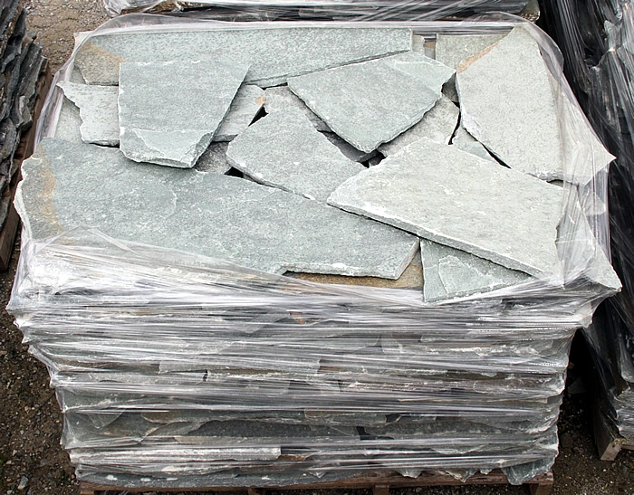 Terra Green stone slabs stacked on a pallet